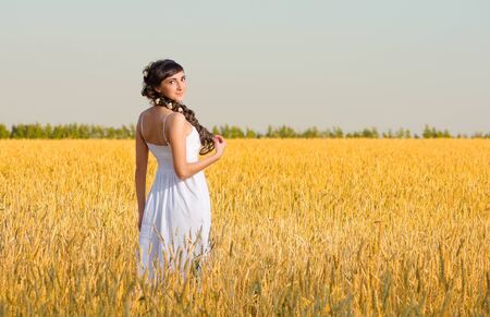 Young girl on wheat fieldの写真素材