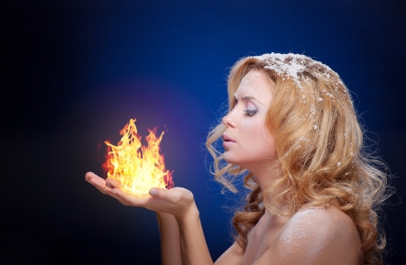Frozen girl hold a falme in palms (little flame)の写真素材