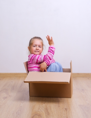 Little curious girl in a boxの写真素材