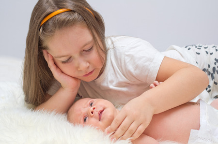 Little baby with her sisterの写真素材