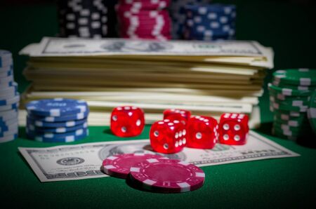 Playing chips dices and dollars on green tableの写真素材