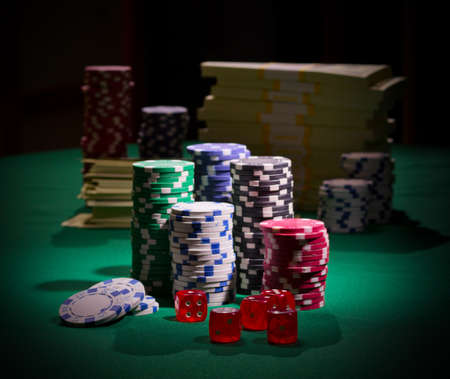 Dollars chips and dices on green table