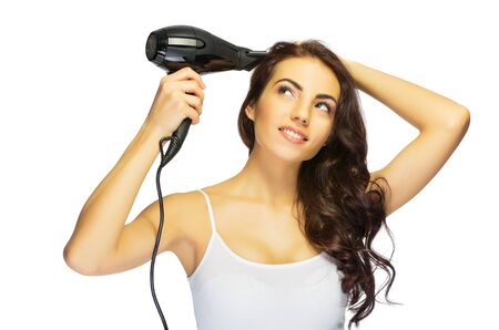 Young healthy girl with hair dryer isolatedの写真素材