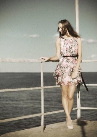 Young girl on the pier (ancient version)の写真素材