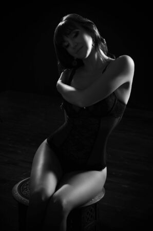 Low key portrait of woman in lingerieの写真素材
