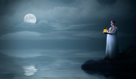 Elven girl on sea coast at nightの写真素材
