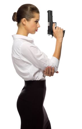 Young businesswoman with gun isolatedの写真素材