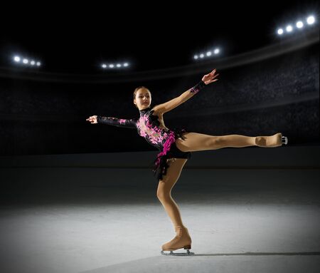Young girl figure skater (on ice arena with spotlights ver)の写真素材