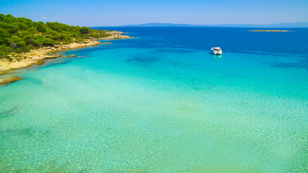 Blue sea shore under clear skyの写真素材