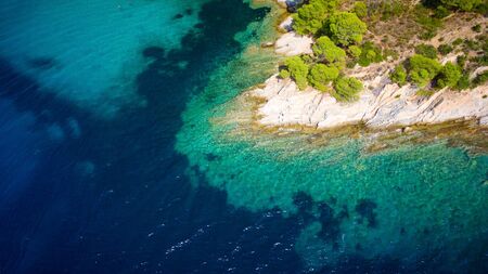 Blue sea shore under clear skyの写真素材