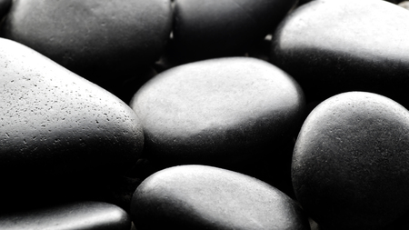 Black pebbles background backliteの写真素材