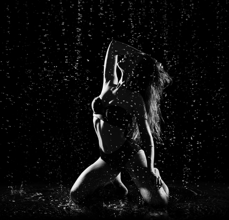 Young woman with water drops (monochrome)の写真素材