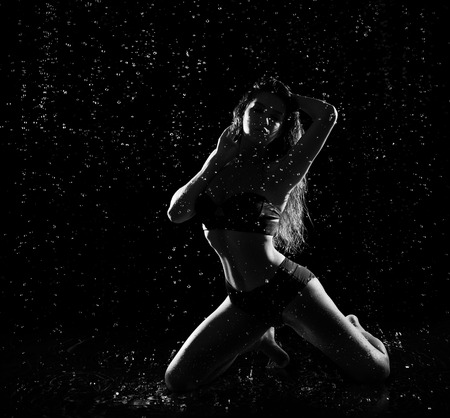 Young woman with water drops (monochrome)の写真素材