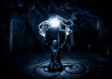 Scary witch in night forestの写真素材