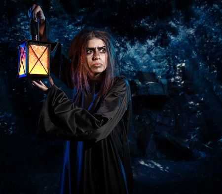 Scary witch in night forest versionの写真素材