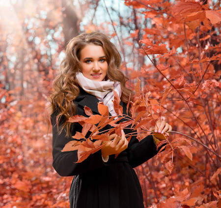 Young girl in autumn forestの写真素材