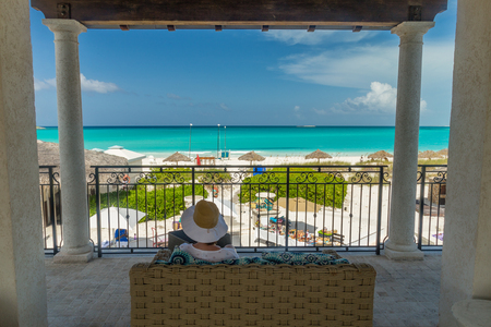 Beach hat woman enjoying view palapas beach Exuma, Bahamasの写真素材