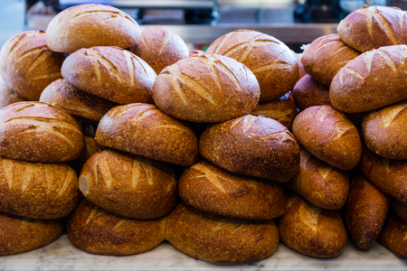 Fresh sourdough bread stacked in a bakery ready to sell and eatの写真素材