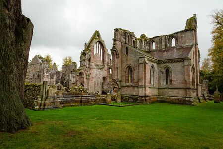 Moody soft light falls on Dryburgh Abbey ruins in the Borders area of Scotland, United Kingdomの写真素材