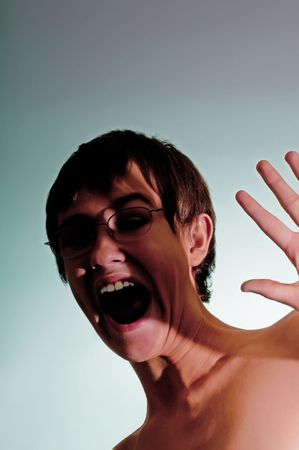 Teenage boy showing terror and fear from an unknown assailant.の写真素材