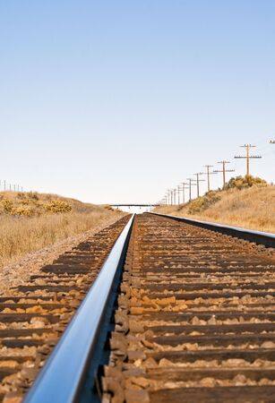 Railroad track across empty rural country giving the sense of time and distance.の写真素材