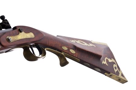 Close up view of a flint lock rifle and the brass inlays and engravings on the stock.の写真素材