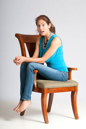 Pretty multi-ethnic young woman being surprised with some recent news.の写真素材