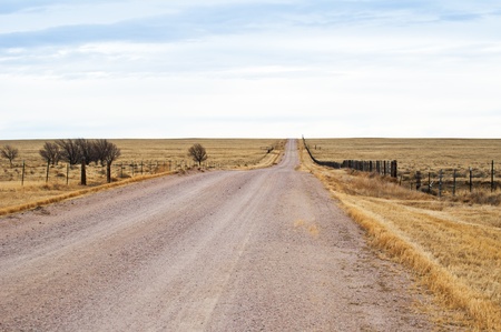 Gravel road though rural Eastern Colorado, USA. Long, straight, and dusty.の写真素材