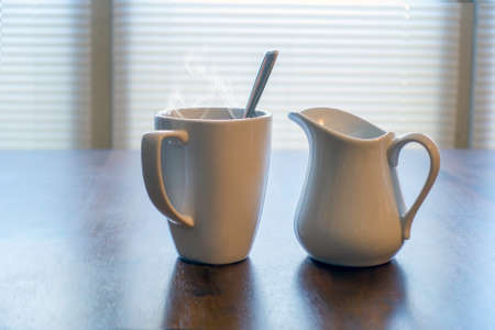 Fresh cup of coffee with cream for a morning eye-opener.の写真素材