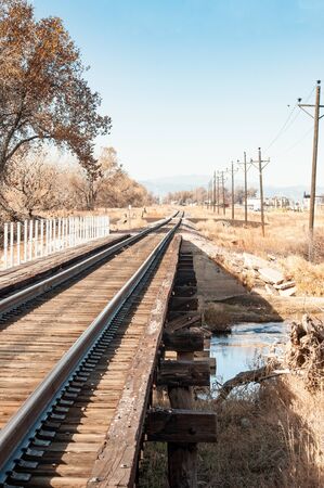 Railroad bridge crossing the Cache La Poudre river on a trestle neart the bike trail.