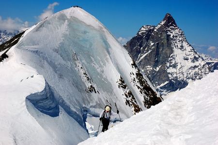 Group of backcountry skiers (ski touring), on background the Matterhorn, west alps, Europe.の写真素材