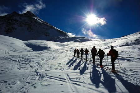 Group of backcountry skiers (ski touring), west alps, Europe.