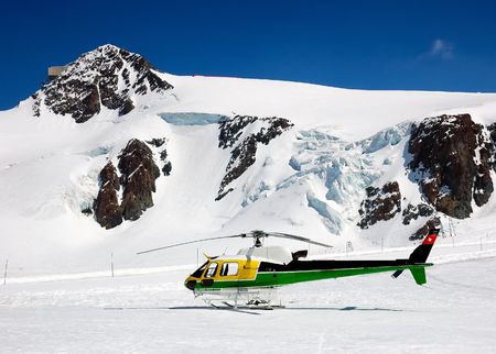 Rescue and heli-ski helicopter parked in the mountainsの写真素材