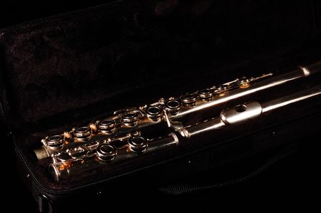 A closed hole "Take-down" flute in case, black backgroundの写真素材