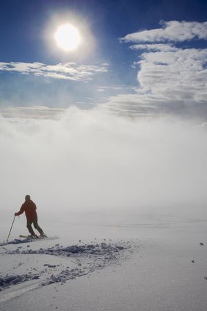 A lone skier skiing in fresh snowの写真素材