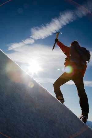 Lone male mountain climber climbing a snowy ridge; Mont Blanc, Europe.の写真素材