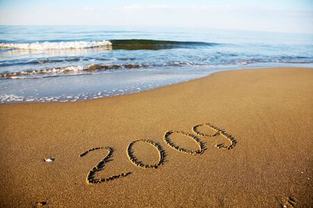 Number 2009 written in the sand of the bechの写真素材