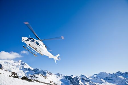 Heli Skiing Helicopter is landing on a ski slope in Gressoney Ski Resort, Aosta, Italy.の写真素材
