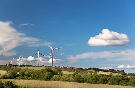 Power Generating Windmills in a countryside landscape, summer and clear sky.の写真素材
