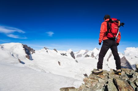 Male hiker standing in front of Monte Rosa Glacier during an high altitude hiking. Switzerland, Europe.の写真素材