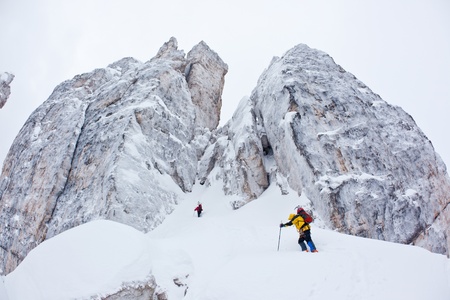 Two climbers approach to the steep face of the Cinque Torri, Dolomiti, Italy.の写真素材