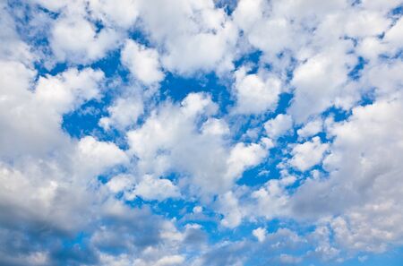 White clouds over a deep blue skyの写真素材