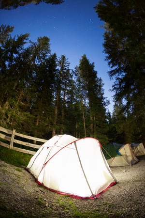 Evening lit tent in camping  Dolomities, Italian Alps, Europe  Concept  nature, vacation, outdoorの写真素材