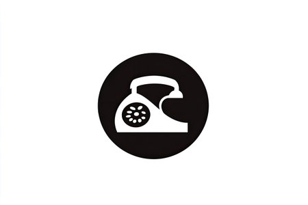 Circular icon in black and white depicts a vintage rotary telephone. The telephone is portrayed in a simplified, stylized manner.の素材