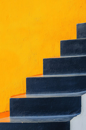 A close-up of navy blue and orange concrete stairs, against an off-white wall. The background is a bright yellow color, creating a striking contrast with the dark hues of the staircase. This minimalist composition emphasizes architectural details while maintaining simplicity in design. The photograph has a soft focus, giving it a clean aesthetic. --ar 2:3 --v 6.1 Job ID: b4a5cd38-7095-4631-9561-e0959f117d34の素材