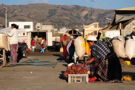 Ecuador, Saquisili - September 08  Ecuadorian ethnic women in national clothes selling agricultural products and other food items on a market in the Saquisili village on September 08, 2012 in Saquisiliのeditorial素材