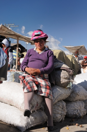 Ecuador, Saquisili - September 08  Ecuadorian ethnic women in national clothes selling agricultural products and other food items on a market in the Saquisili village on September 08, 2012 in Saquisiliのeditorial素材