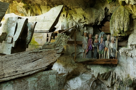 iNDONESIA, Tana Toraja - Ancient cave tomb  The cave is guarded by a balcony of tau tau  Inside the cave is a colection of coffins with the bones either scattered or heaped in piles  South Sulawesi, Indonesia  のeditorial素材