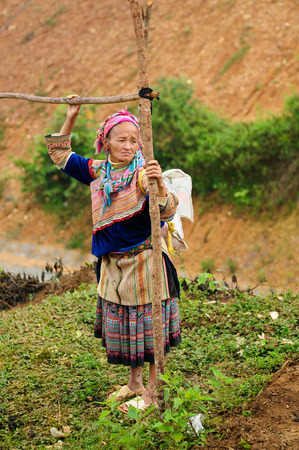 Sapa, Vietnam - October 22:  Woman in the traditional dress of Homong people settling on the  mountain regions of the Sapa town  on  October 22, 2010のeditorial素材