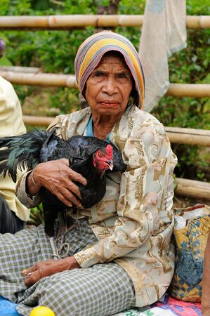 SOE, TIMOR, INDONESIA - APRIL 26: For seller of chicken in the traditional exotic tribal market (pasar) in Indonesia on the Timor island. Soe on April 26, 2011.のeditorial素材